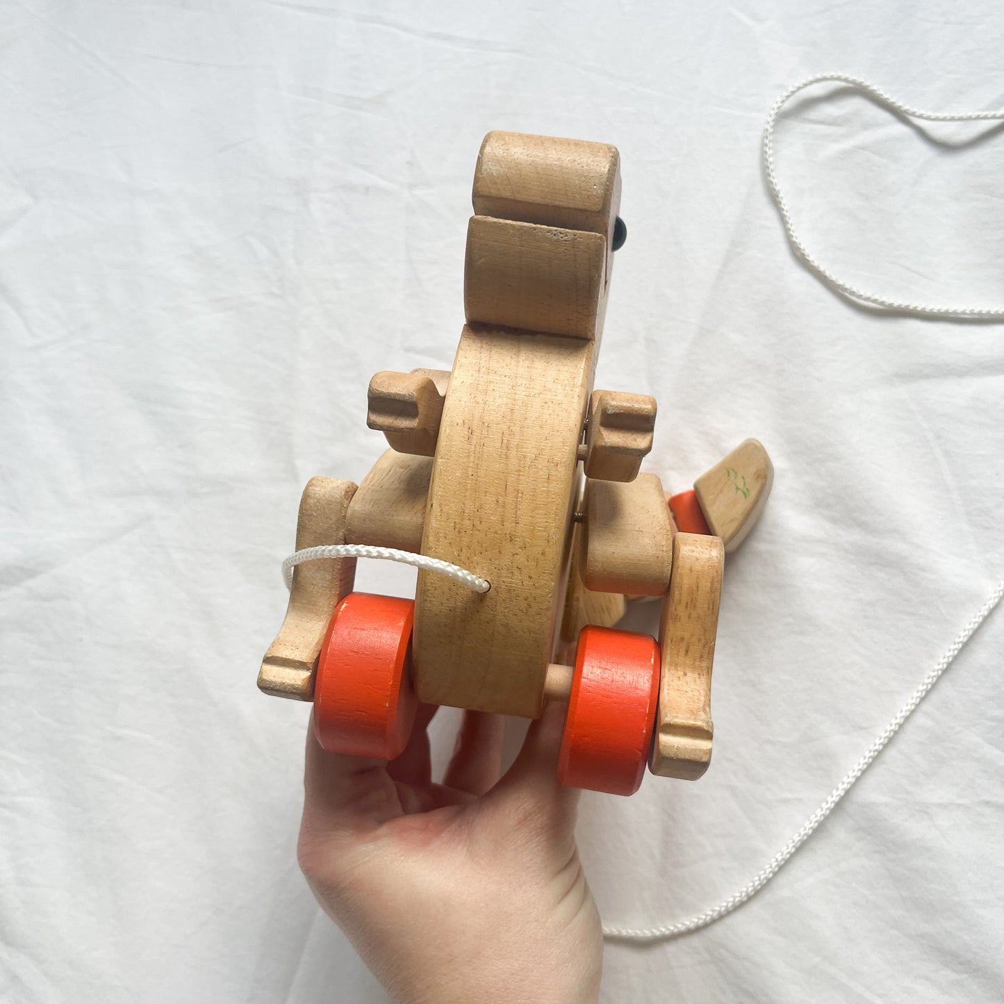 Wooden pull along dinosaur
